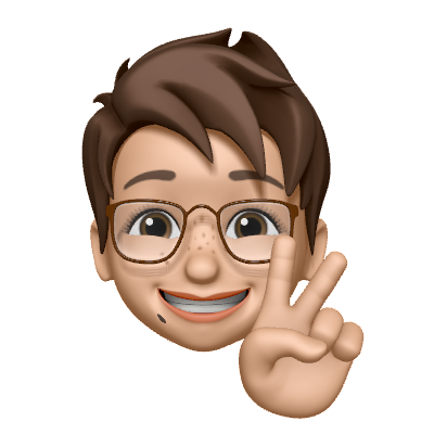 Cartoon of a caucasian woman with dark brown hair (in a pixie cut) and dark-rimmed glasses, one hand visible (in a 'Peace' sign)